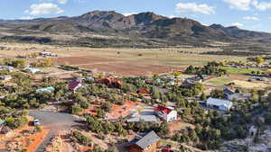 Aerial view of property's location with a mountainous background, rural landscape, and nearby suburban area