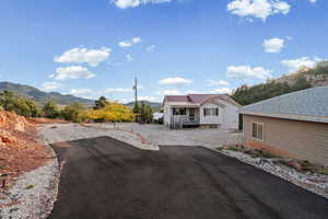 View of asphalt driveway with a mountain view