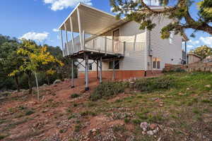 View of side of home featuring a wooden deck