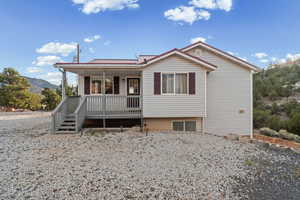 Single story home featuring a porch, a metal roof, and a mountain view