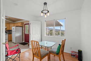 Dining space with light wood-style floors, healthy amount of natural light, and a mountain view