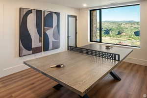 Dining space with wood finished floors, a mountain view, and recessed lighting