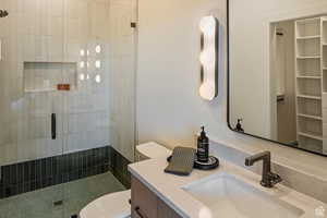 Bathroom featuring a stall shower and vanity