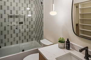 Full bathroom featuring shower / bath combination with glass door and vanity