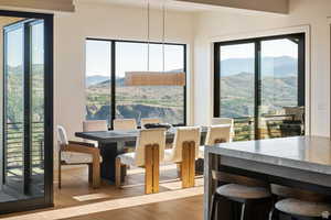 Dining area with light wood finished floors and a mountain view