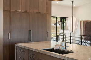 Bar featuring light stone countertops and recessed lighting