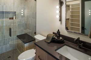 Full bathroom with vanity and a shower stall
