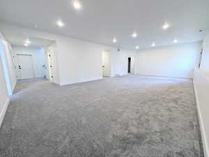 Spare room with recessed lighting and light carpet