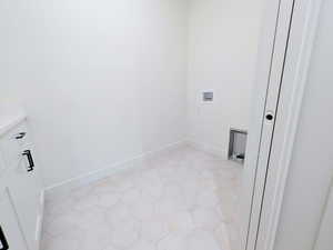 Laundry room featuring baseboards and washer hookup