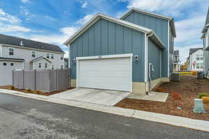 Garage featuring concrete driveway