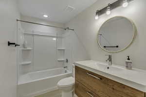 Full bathroom featuring vanity, shower / tub combination, and recessed lighting