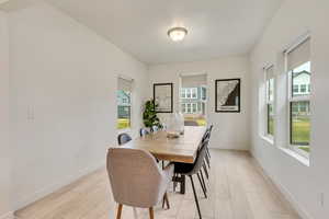 Dining space with baseboards and wood tiled floors