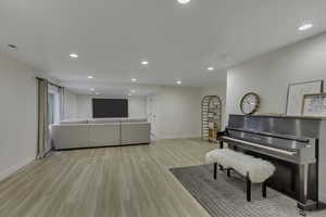 Living room featuring light wood-style floors and recessed lighting