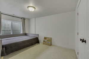 Bedroom with carpet and a textured ceiling