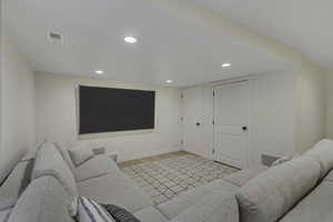 Living room with recessed lighting and light wood-type flooring