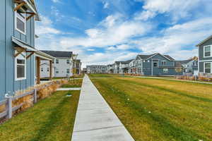 View of green lawn with a residential view