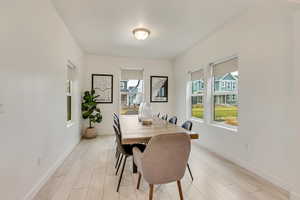 Dining space featuring plenty of natural light and light wood finished floors