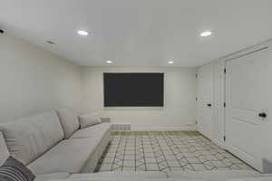 Living room with light wood-style flooring and recessed lighting