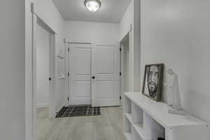 Hallway with wood finish floors and baseboards