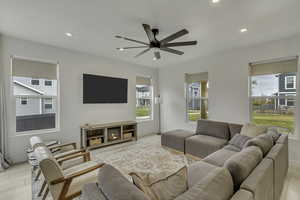 Living area with recessed lighting, light wood-style flooring, and ceiling fan