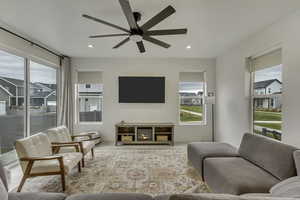 Living area featuring a ceiling fan and recessed lighting