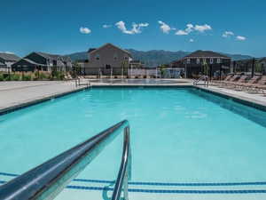Community pool featuring a residential view and a patio