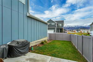 Fenced backyard featuring a mountain view and a residential view
