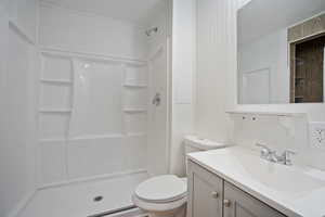Bathroom featuring vanity and a stall shower