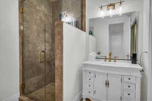 Full bathroom featuring a shower stall and vanity