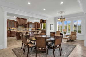 Dining space featuring ornamental molding, recessed lighting, a chandelier, and light tile patterned floors