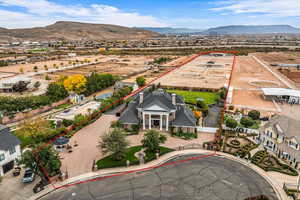 Aerial perspective of suburban area with property boundaries highlighted and a mountainous background
