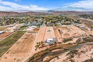 Aerial perspective of suburban area featuring property parcel outlined and a mountainous background