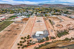 Aerial view of residential area featuring a mountainous background and property boundaries highlighted