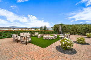 View of patio with an outdoor living space with a fire pit