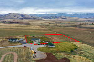 Overview of rural landscape featuring property boundaries highlighted and a mountainous background