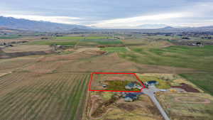 Aerial overview of property's location with rural landscape, property boundaries highlighted, and mountains