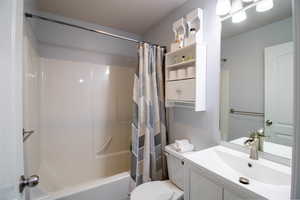Bathroom featuring vanity and shower / bath combo with shower curtain