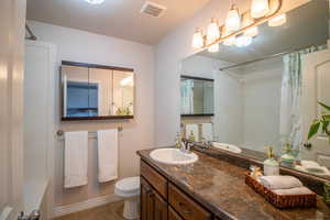 Full bath featuring vanity and tile patterned floors