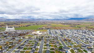 Aerial view of property's location featuring nearby suburban area and a mountainous background