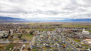 Aerial view of property's location with nearby suburban area and a mountainous background