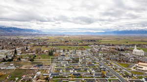 Aerial overview of property's location featuring nearby suburban area and a mountain backdrop