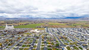 Aerial view of property's location featuring nearby suburban area and a mountain backdrop
