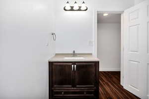 Bathroom with vanity and dark wood-style flooring