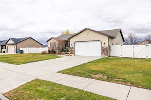Single story home with a gate, concrete driveway, and a garage