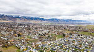 Aerial overview of property's location with nearby suburban area and a mountain backdrop