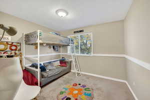 Carpeted bedroom with baseboards and a textured ceiling