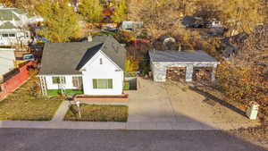 View of front of home featuring a residential view, stucco siding, roof with shingles, and driveway