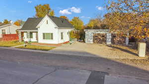 View of front facade with a shingled roof, stucco siding, a garage, and driveway