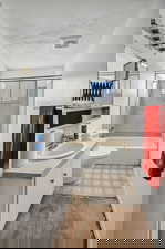 Full bath with shower / tub combination, vanity, light flooring, and a textured ceiling