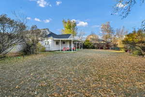 Back of house with a patio area and a yard